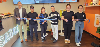 A group of people are holding ribbons in a restaurant. AI generated content