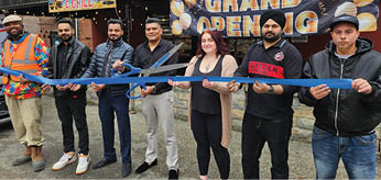 A group of people are standing in front of a building, holding a ribbon. AI generated content