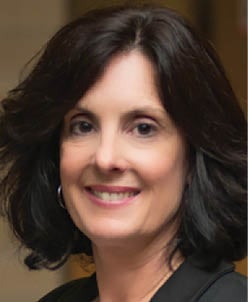 A woman with dark hair and a black shirt smiles for the camera. AI generated content