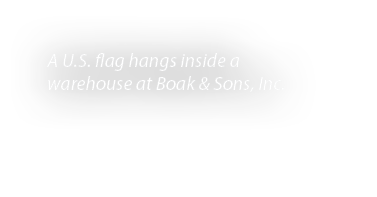 A U.S. flag hangs inside a warehouse at Boak & Sons, Inc. 