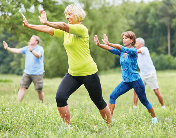 A group of people are doing yoga in a field. Description generated by AI