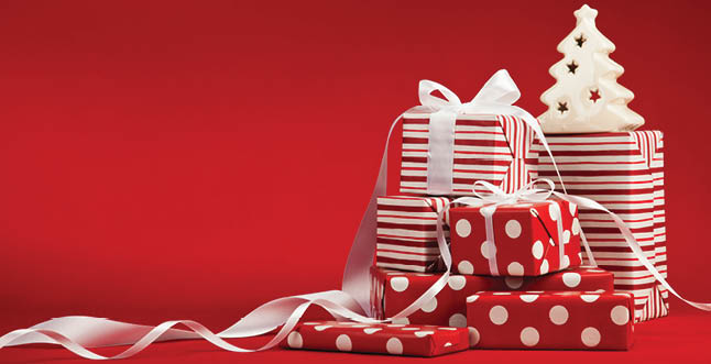 Christmas gifts with ribbon on a red background