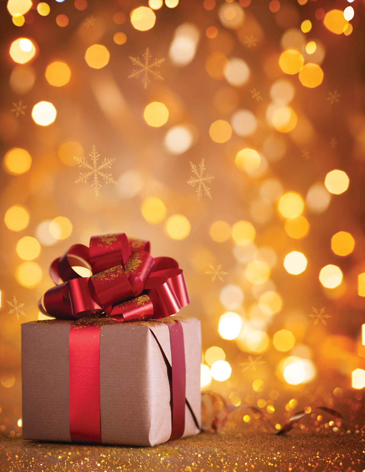 Gift box with red ribbon against magic golden lights and bokeh background. Christmas holiday greeting card with copy space.